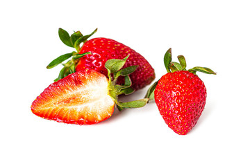 Red, juicy strawberries with green leaves on white