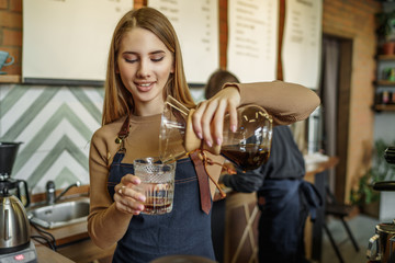 Coffee set, pour over and coffe kettle. Barista woman doing alternative brewing method