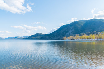 Scenic view of Skaha Lake on sunny afternoon with mountains and blue sky