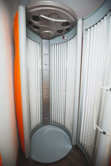 Vertical tanning bed in a beauty and care studio. Tanning equipment.