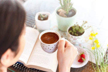 Warm and comfortable reading books and drinking coffee at home. having a good time at home

