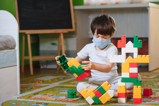 Kid Boy Playing With Colorful Plastic Blocks And Creating Train Station. Child Having Fun With Building Railway Toys During Coronavirus Quarantine Staying At Home. Shelter In Place, Lockdown Concept.