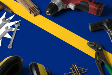 Nauru flag on repair tool concept wooden table background. Mechanical service theme with national...