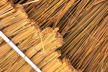 Close up detail of yellow straw roof.