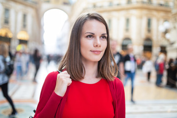 Smiling young woman shopping in Milan, Italy