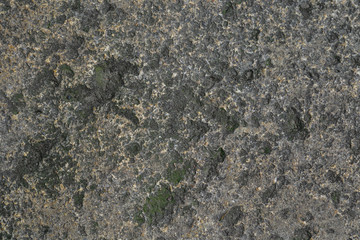 Cobblestone texture.Marble and granite drainage system closeup.Concrete wall with gravel. Gray foundation of the house.