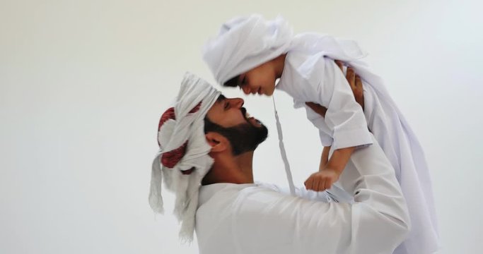 Dad spending time with his children in Dubai. Happy family wearing traditional united arab emirates outfits