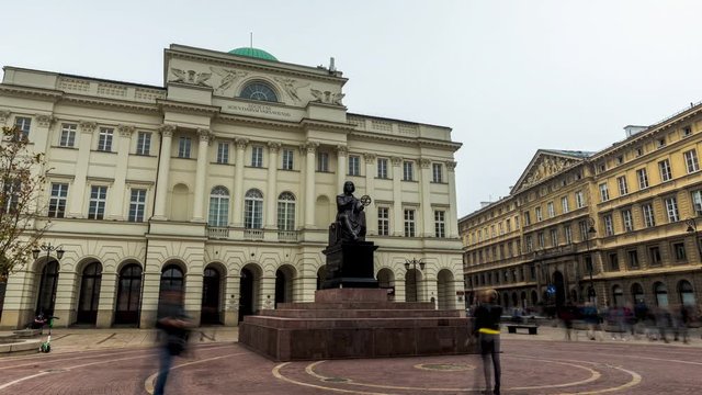 Hyperlapse of Statue Of Astronomer Nicolaus Copernicus in Warsaw, Poland, with tourists taking photos 