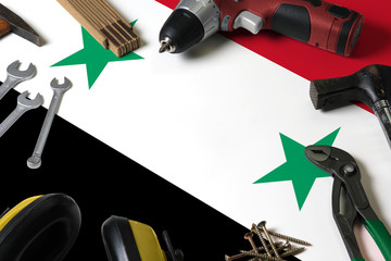Syria flag on repair tool concept wooden table background. Mechanical service theme with national...