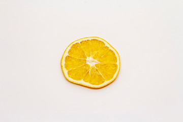 Dried single slice of orange isolated on white background