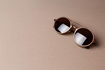 Brown classy sunglasses on minimal paper background