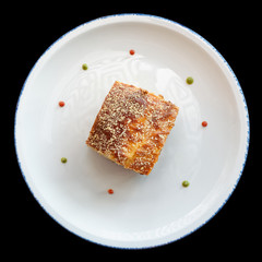 Slice of moussaka, traditional Greek and Balkan dish, isolated on black