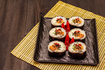Korean roll Gimbap(kimbob). Steamed white rice (bap) and various other ingredients. Trendy black background