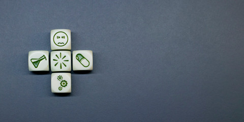 Closeup of toy blocks with pill, flask, coronavirus and sick patient. Medical and health insurance...