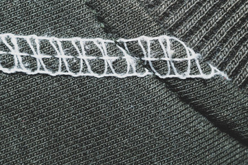 White seams on black fabric. stitches on textile material