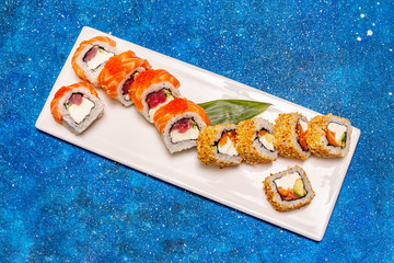 Assorted sushi set. Japanese or Korean roll with different fresh ingredients. Nautical background