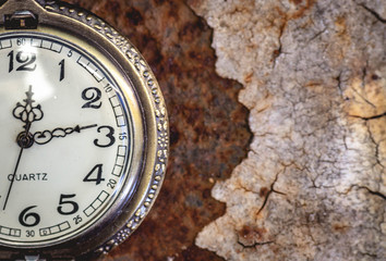 Vintage pocket watch showing time with textured background. concept of time