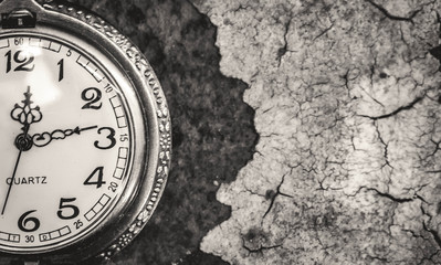 Vintage pocket watch showing time with textured background. concept of time