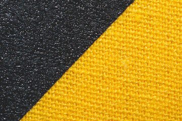 Black and yellow fabric texture. knitted textile close up. woven background