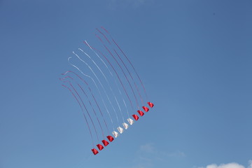 flight of a kite, WIND IN THE SKY, RED AND WHITE KITE, BLUE SKY