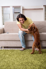 Young man with cocker spaniel dog