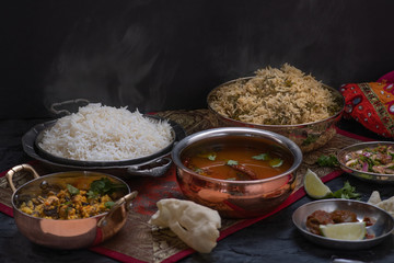South Indian vegan pilaf, rice and side dishes on dark table