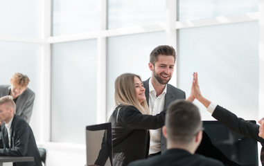 happy employees giving each other a high five.