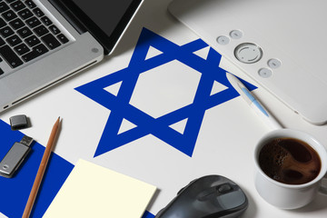 Israel national flag on top view work space of creative designer with laptop, computer keyboard,...