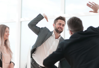 Fototapeta premium happy employees giving each other a high five.