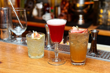 Three cocktails on bar counter