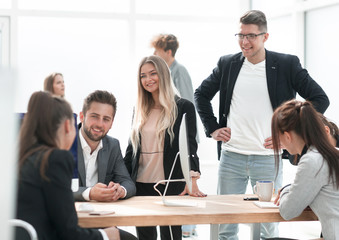 business team discussing work issues near the desktop .