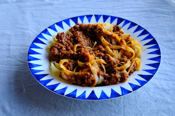 Tagliatelle al ragù alla Bolognese - long, flat egg pasta with a meat sauce or Bolognese sauce.