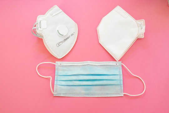 Surgical mask with rubber ear straps. Typical 3-ply surgical mask, masks pff2 and pff3 against covid. Procedure mask from bacteria. Protection concept.