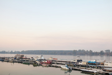 Boats anchored on the port and harbour of Zemun, on the typical pontoon of the Zemunski marina, in belgrade, Serbia, one of the main navigation hubs on the Danube river.