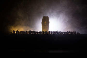Naklejka na ściany i meble Coronavirus 2019-nCov novel coronavirus concept. Crowd looking on big Corona virus model at night with fog and backlight. Creative artwork decoration. Selective focus.