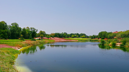 Fototapeta na wymiar beautiful lake near the golf course in a sunny day