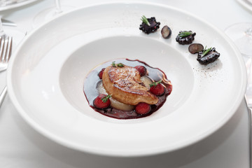 Foie gras with port sauce on table