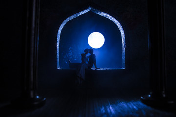 Obraz premium Beautiful arabian interior realistic miniature. Table decoration. Romantic couple at window.