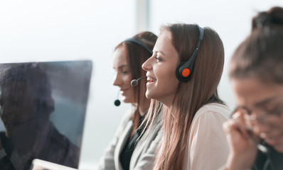 smiling call center operator sitting at his Desk