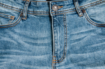 Denim pants in blue on a wooden background