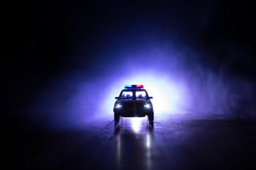 Police cars at night. Police car chasing a car at night with fog background. 911 Emergency response...