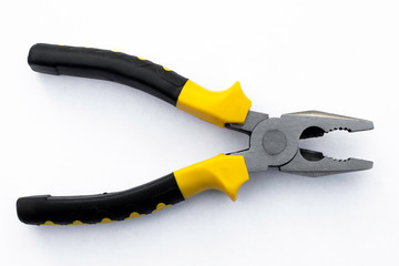 Obraz premium black and yellow pliers on white background