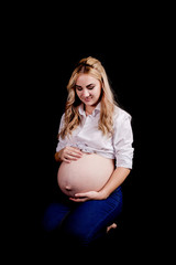 pregnant girl on black background