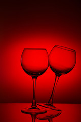 Wine glasses composition on red.