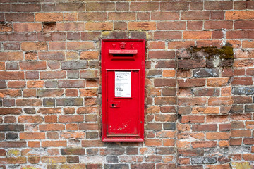 British mailbox on a brick wall in England