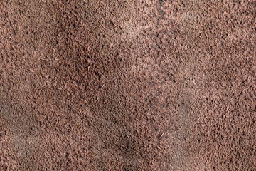 Background of natural cinnamon suede. Crafted hide and leather are used for tailoring fashionable comfortable outerwear, shoes and accessories.