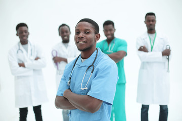 young medic standing in front of his friends colleagues