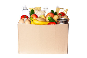 Various grocery items in cardboard box isolated on white background. Food box with fresh...