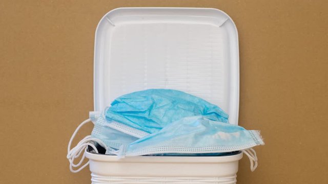 trash bin full of coronavirus masks