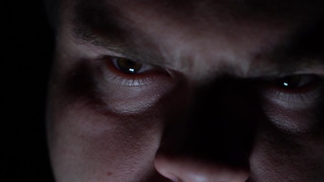 Maniac in the dark stands and smiles viciously. Looking at the victim